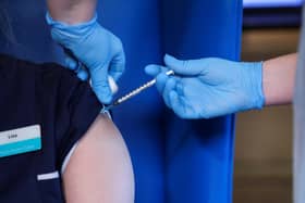 A member of staff receives the Pfizer/BioNTech COVID-19 vaccine at the Abercorn House Care Home in Hamilton.