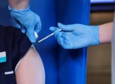 A member of staff receives the Pfizer/BioNTech COVID-19 vaccine at the Abercorn House Care Home in Hamilton.