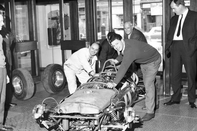 Employees had to take the wheels off a racing car to get it into the foyer of the Odeon CInema, in Edinburgh, for a film premiere in May 1966.