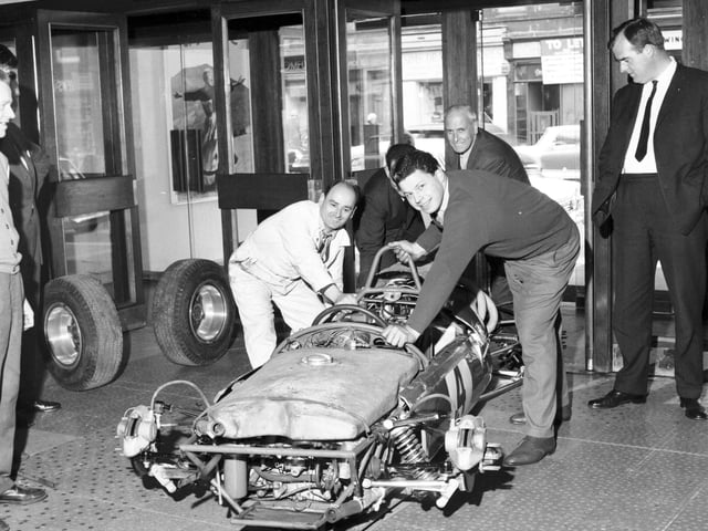 Employees had to take the wheels off a racing car to get it into the foyer of the Odeon CInema, in Edinburgh, for a film premiere in May 1966.