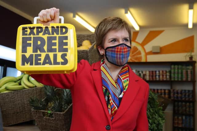 First Minister Nicola Sturgeon holds a lunch box inside The People's Pantry in Glasgow, during campaigning for the Scottish Parliamentary election (PA Media)