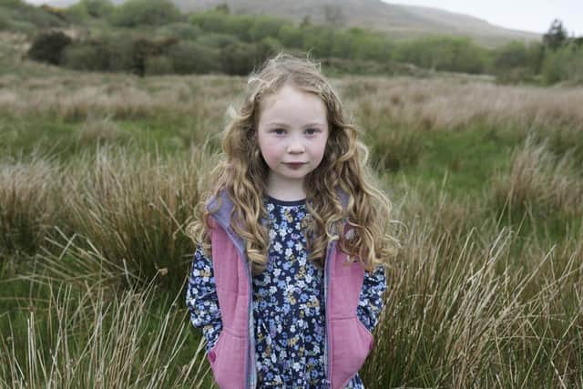 Young islander Rosie on land close to her home, symbolising the link between her childhood on the island and her family's enduring connection to this place across generations. PIC: Margaret Mitchell, 2024