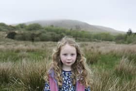 Young islander Rosie on land close to her home, symbolising the link between her childhood on the island and her family's enduring connection to this place across generations. PIC: Margaret Mitchell, 2024