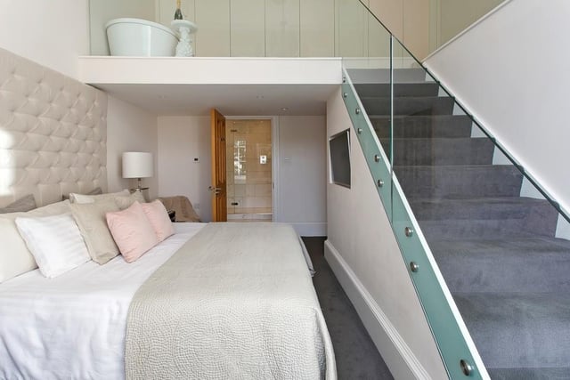 The master bedroom features a staircase leading to the mezzanine, where there is a stand-alone bath, fitted wardrobes and space which can be utilised as a dressing room/ home office or gym.