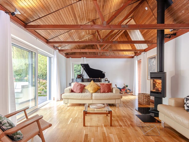 Interior Its distinctive lounge has a vaulted cedar wood ceiling, log burner and full-height windows. The dining room features exposed timber trusses and the Ashley Ann kitchen offers the convenience of a Quooker tap.