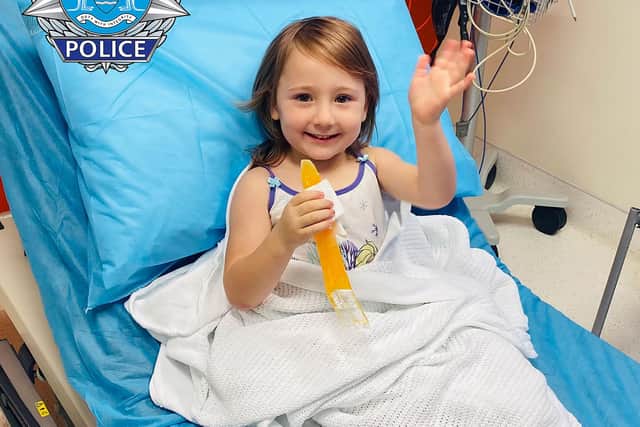 Four-year-old Cleo Smith waves as she sits on a bed in hospital in Carnarvon, western Australia. (Picture credit: Western Australia Police via AP)