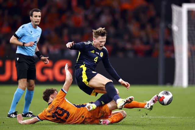 Scotland's Scott McTominay feels the force of a challenge from Netherlands' Mats Wieffer. (Photo by MAURICE VAN STEEN/ANP/AFP via Getty Images)