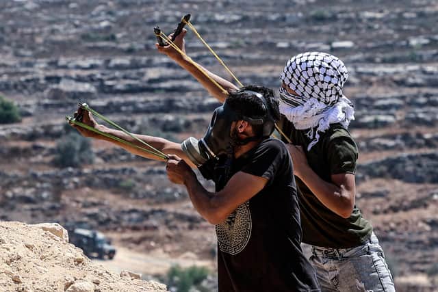 Palestinian protesters hurl rocks at Israeli forces in Beita (Picture: Jaafar Ashtiyeh/AFP via Getty Images)