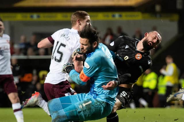 Hearts goalkeeper Craig Gordon was badly injured in this collision with Dundee United striker Steven Fletcher.