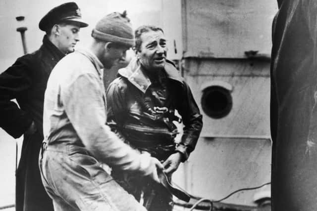 Royal Navy frogman Lionel 'Buster' Crabb preparing for a dive in Tobermory Bay, where treasure is believed to lie in a 300 year-old shipwreck, on April 11 1950. (Photo by Keystone/Hulton Archive/Getty Images)