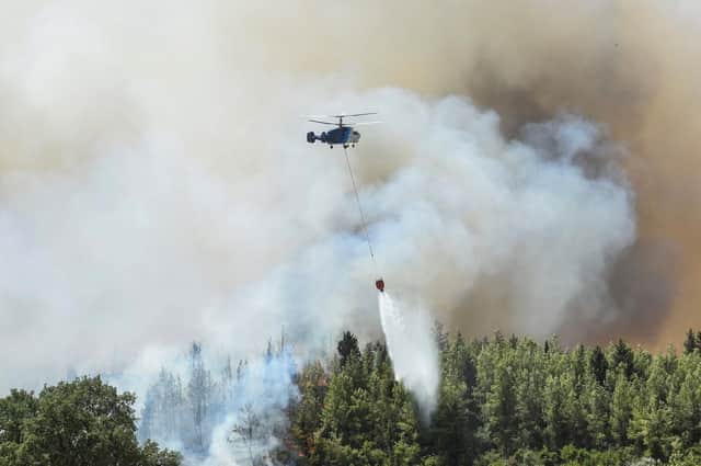 Helicopter pours star on wildfires in Kacarlar village near the Mediterranean coastal town of Manavgat, Antalya, Turkey, at the end of last month. Techniques forged on the grouse moors of Scotland could travel far and wide to help the global defence against rising numbers of wildfires due to climate change, argues Ross Ewing.  Mandatory Credit: Photo by Uncredited/AP/Shutterstock (12240696h)