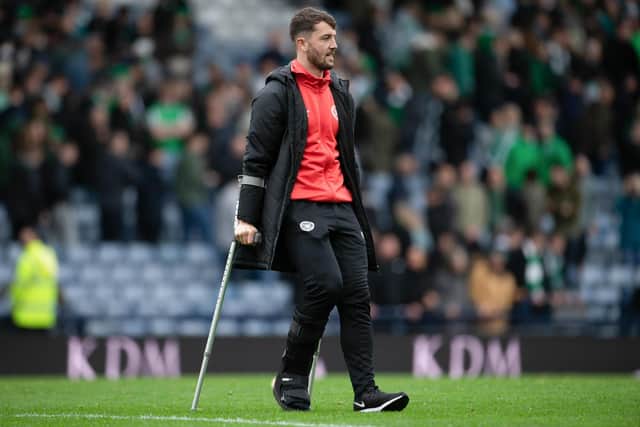 Hearts' Craig Halkett on crutches at full time after the win over Hibs.