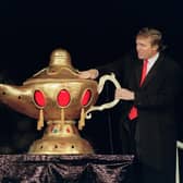 In 1990, the then real estate developer Donald Trump rubs a "magic lamp" during the opening ceremony for his Taj Mahal casino in Atlantic city (Picture: Bill Swersey/AFP via Getty Images)