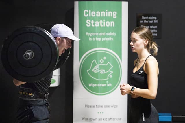 Gym members work out alongside one of the Cleaning Stations at the new PureGym Local in Kirkcaldy, Fife.
