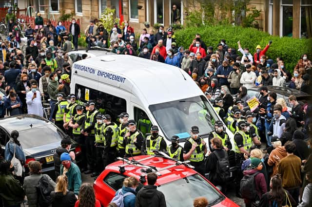 Protesters block a UK Home Office van to prevent it leaving Kenmure Street in Glasgow last week (Picture: Jeff J Mitchell/Getty Images)