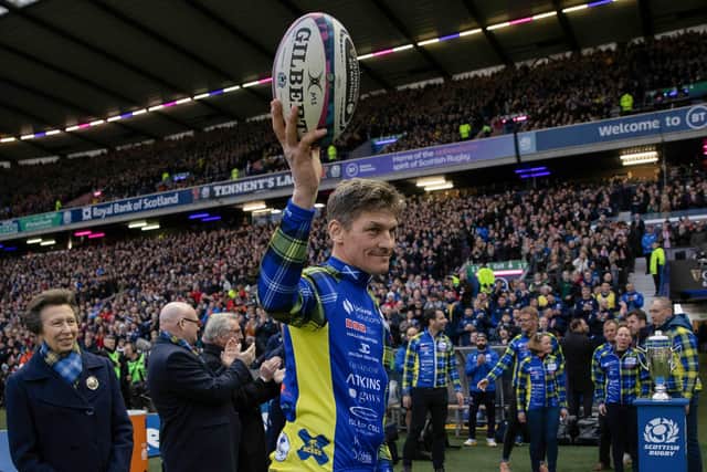 Rob Wainwright delivers the match ball after cycling from Cardiff in aid of Doddie Weir during a Guinness Six Nations match between Scotland and Wales at Murrayfield.