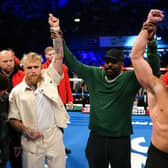 Jake Paul and Tommy Fury pose after a face-off in the ring, alongside Derek Chisora at the OVO Arena Wembley, London.