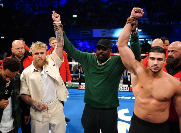 Jake Paul and Tommy Fury pose after a face-off in the ring, alongside Derek Chisora at the OVO Arena Wembley, London.