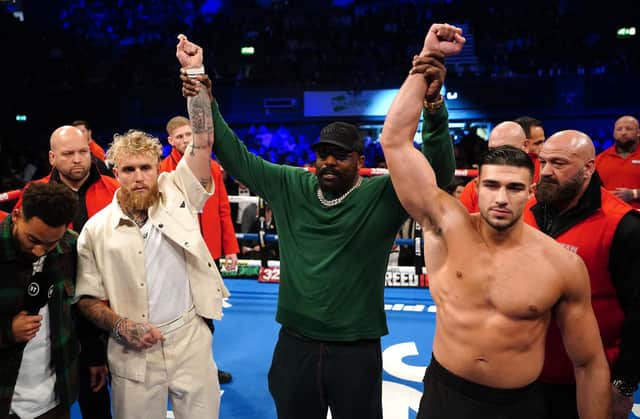 Jake Paul and Tommy Fury pose after a face-off in the ring, alongside Derek Chisora at the OVO Arena Wembley, London.