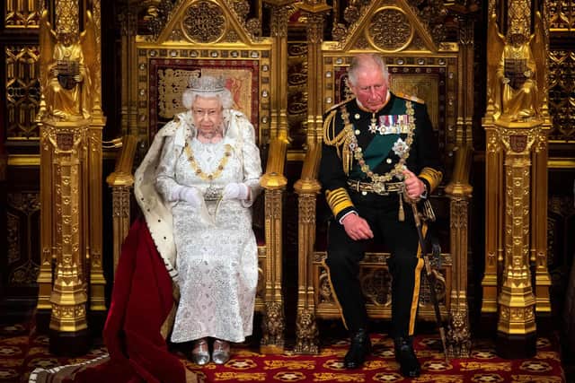 Queen Elizabeth II sits with Prince Charles on the Sovereign's throne to deliver the Queen's Speech at the State Opening of Parliament in 2021. Photo: Victoria Jones / POOL / AFP via Getty Images.