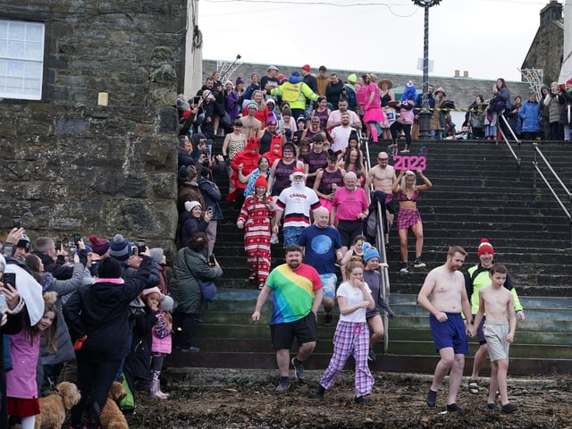 People take part in the Loony Dook New Year's Day dip in the Firth of Forth at South Queensferry