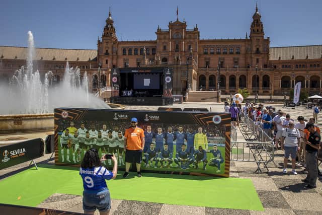 A Rangers fan poses at a photocall in the Fan Festival zone at Plaza de Espana