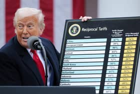 President Donald Trump holds up a chart while speaking during a “Make America Wealthy Again” trade announcement event in the Rose Garden 