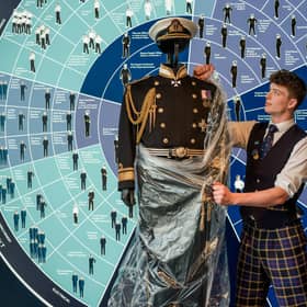 Conall Burns (Sales Assistant) unwraps The No.1 Dress Uniform of Rear Admiral Sir Robert Woodard KCVO DL, Britannia’s last Admiral, for display.