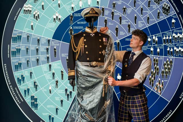 Conall Burns (Sales Assistant) unwraps The No.1 Dress Uniform of Rear Admiral Sir Robert Woodard KCVO DL, Britannia’s last Admiral, for display.