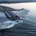 This screen grab from a video posted on Ukraine's president Volodymyr Zelensky's Twitter account shows an aerial view of the dam of the Kakhovka Hydroelectric Power Station after it was partially destroyed. Picture: Twitter/@ZelenskyyUa Twitter acc/AFP via Getty Images