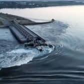 This screen grab from a video posted on Ukraine's president Volodymyr Zelensky's Twitter account shows an aerial view of the dam of the Kakhovka Hydroelectric Power Station after it was partially destroyed. Picture: Twitter/@ZelenskyyUa Twitter acc/AFP via Getty Images