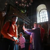 Christian worshipers take photographs inside the Church of the Nativity, believed to be the birthplace of Jesus Christ, in the West Bank town of Bethlehem (Picture: Musa al-Shaer/AFP via Getty Images)