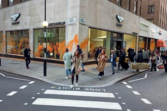 Handout photo issued by Just Stop Oil of a Bentley car showroom on Berkley Square in central London which has been sprayed with paint by Just Stop Oil protesters. Picture date: Wednesday October 26, 2022.