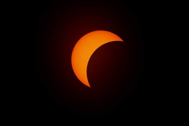 The moon begins to eclipse the sun in Fort Worth, Texas. Photo by Ron Jenkins/Getty Images