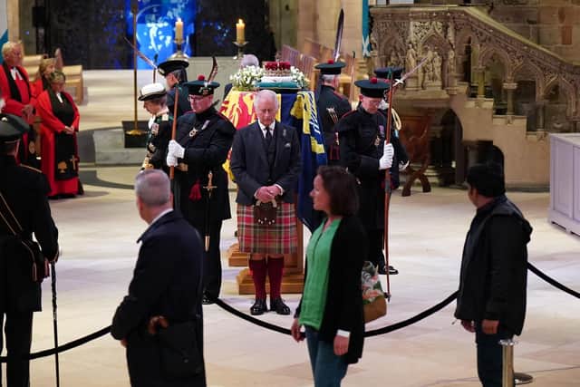 King Charles III and other members of the royal family hold a vigil at St Giles' Cathedral, Edinburgh, in honour of Queen Elizabeth II as members of the public walk past.