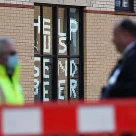 A sign saying 'help us, send beer' at Murano Street Student Village in Glasgow, where Glasgow University students are being tested at a pop up test centre picture: Andrew Milligan/PA Wire