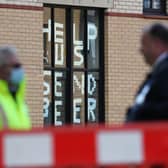A sign saying 'help us, send beer' at Murano Street Student Village in Glasgow, where Glasgow University students are being tested at a pop up test centre picture: Andrew Milligan/PA Wire