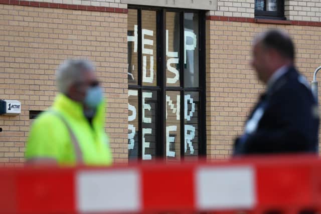 A sign saying 'help us, send beer' at Murano Street Student Village in Glasgow, where Glasgow University students are being tested at a pop up test centre picture: Andrew Milligan/PA Wire