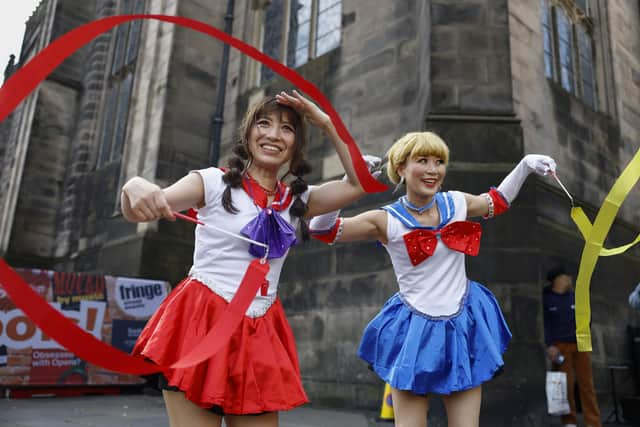 Street entertainers perform on Edinburgh's Royal Mile during the 2023 Fringe.