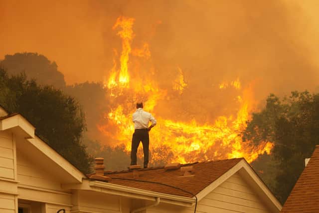 A man watches an approaching wildfire near Camarillo, California (Picture: David McNew/Getty Images)