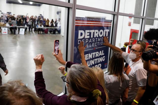 Trump supporters bang on the glass and chant slogans outside a room where absentee ballots were being counted in Detroit, Michigan (Picture: Jeff Kowalsky/AFP via Getty Images)