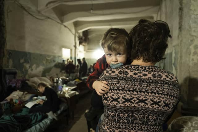 A woman holds a child in an improvised bomb shelter in Mariupol. Picture: AP Photo/Mstyslav Chernov