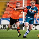 Dundee United's Paul McMullan challenges Liam Grimshaw in the 1-1 draw with Motherwell on Boxing Day. It could be the player's last appearance at Tannadice for United. (Photo by Ross Parker / SNS Group)