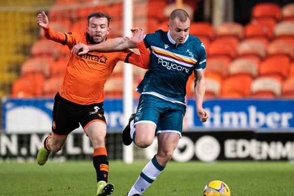 Dundee United's Paul McMullan challenges Liam Grimshaw in the 1-1 draw with Motherwell on Boxing Day. It could be the player's last appearance at Tannadice for United. (Photo by Ross Parker / SNS Group)