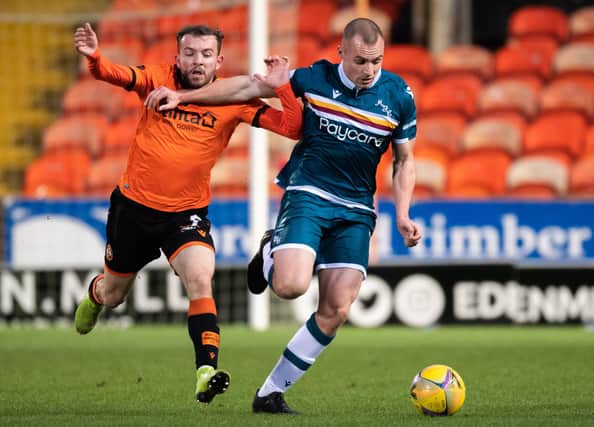 Dundee United's Paul McMullan challenges Liam Grimshaw in the 1-1 draw with Motherwell on Boxing Day. It could be the player's last appearance at Tannadice for United. (Photo by Ross Parker / SNS Group)