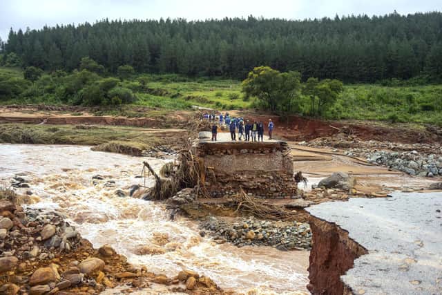 Timber company workers stand stranded on a damaged road in Chimanimani, eastern Zimbabwe, after the area was hit by the Cyclone Idai in 2019 (Picture: Zinyange Auntony/AFP via Getty Images)