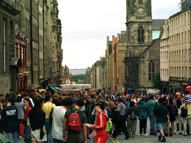 Crowds in the High Street watching street performers during the 1996 Edinburgh Festival.