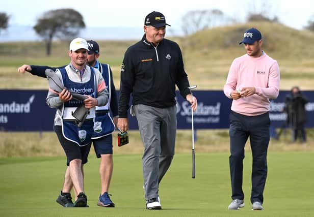 Paul Lawrie leaves the 18th green with his son and caddie Craig Lawrie after completing his last-ever round on the European Tour, having decided this week's Aberdeen Standard Investments Scottish Open at The Renaissance Club would be his 620th and final appearance. Picture: Ross Kinnaird/Getty Images