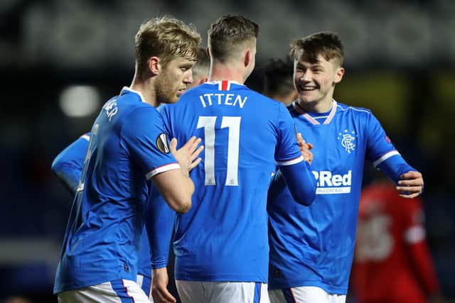 Rangers' Swiss striker Cedric Itten (C) celebrates with teammates after scoring their fifth goal from the penalty spot during the UEFA Europa League Round of 32, 2nd leg football match between Rangers and Royal Antwerp at the Ibrox Stadium in Glasgow on February 25, 2021. - Rangers won the game 5-2. (Photo by RUSSELL CHEYNE / POOL / AFP) (Photo by RUSSELL CHEYNE/POOL/AFP via Getty Images)