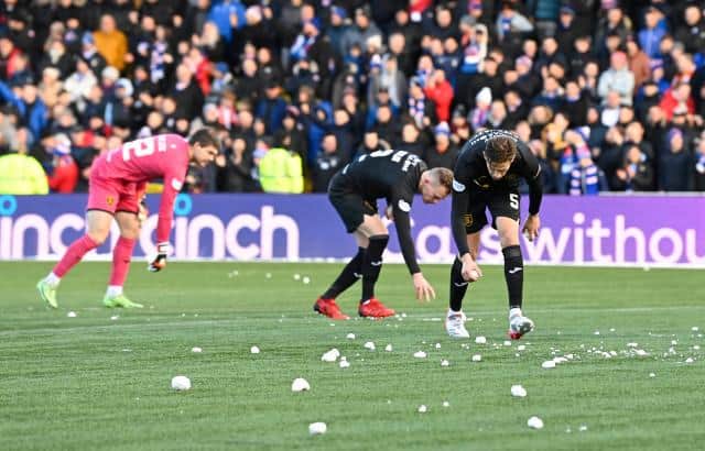 Livingston's players pick up snow balls during a Cinch Premiership match between Livingston and Rangers at Toni Macaroni Arena, on November 28, 2021. (Photo by Rob Casey / SNS Group)